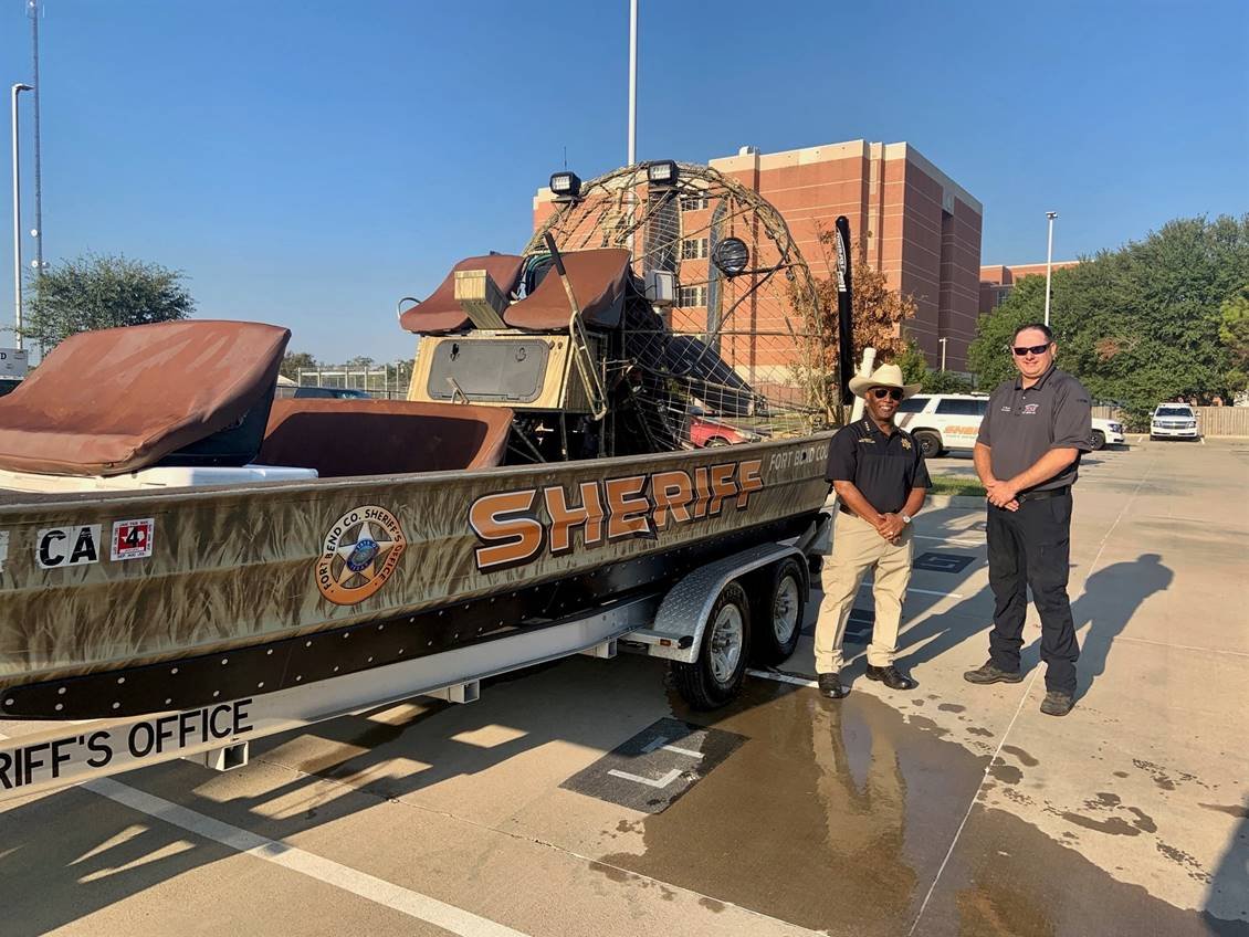 Fort Bend County Sheriff Eric Fagan and Northeast Fort Bend County Fire Chief Travis Baxter pause for a snapshot with the sheriff’s office airboat.